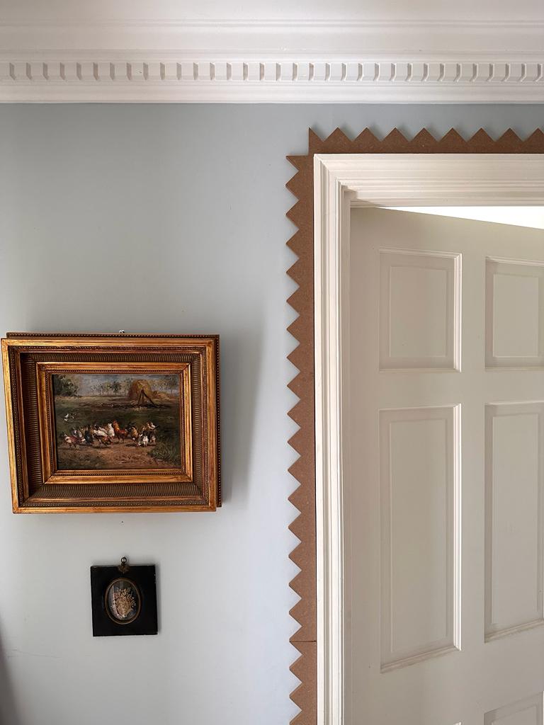 Elegant MDF unpainted zig zag molding around the door frame adding a stylish detail to this transitional interior design.